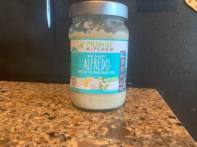primal kitchen alfredo sauce on a counter