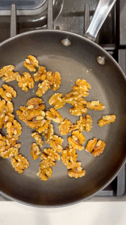 Pour whole walnuts into small pan on low-medium heat and toast
