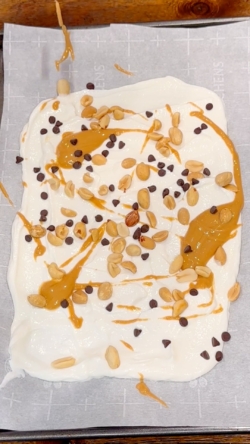 Top with peanut butter, peanuts and chocolate chips.