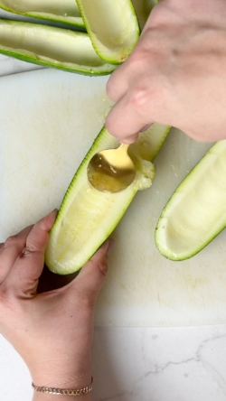 Cut zucchini in half lengthwise and remove the zucchini flesh with a spoon.