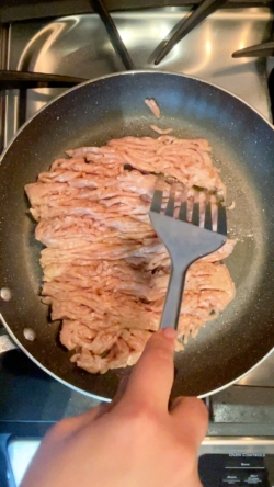 In a pan, cook chicken on medium heat until no longer pink.