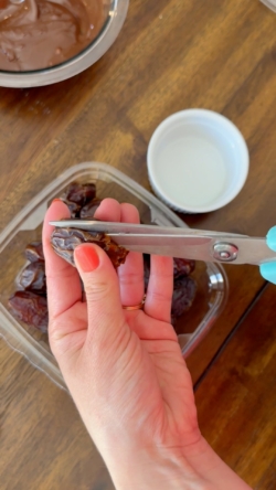 Prep your dates. Using a scissor, cut open each date carefully and remove pit. We are going to close them up once stuffed, so try to keep at least one end of the date intact.