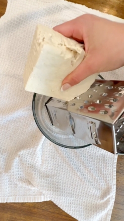 Once tofu has been pressed for 15 minutes, shred using a cheese grater.