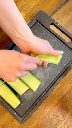 Hollow out the seeds and insides of the cucumber, being careful not to pierce the bottom, with a teaspoon