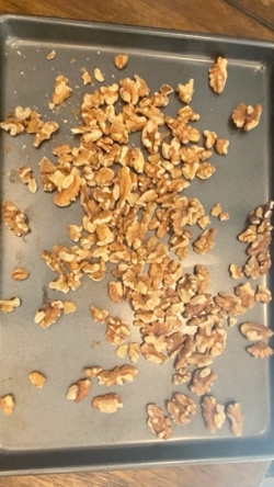 Pour 2 cups of walnuts on a baking sheet and roast for 10 minutes
