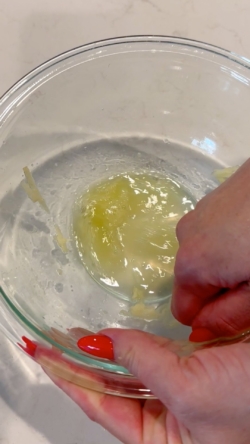 Squeeze the excess liquid from the apple using your hands and discard the liquid