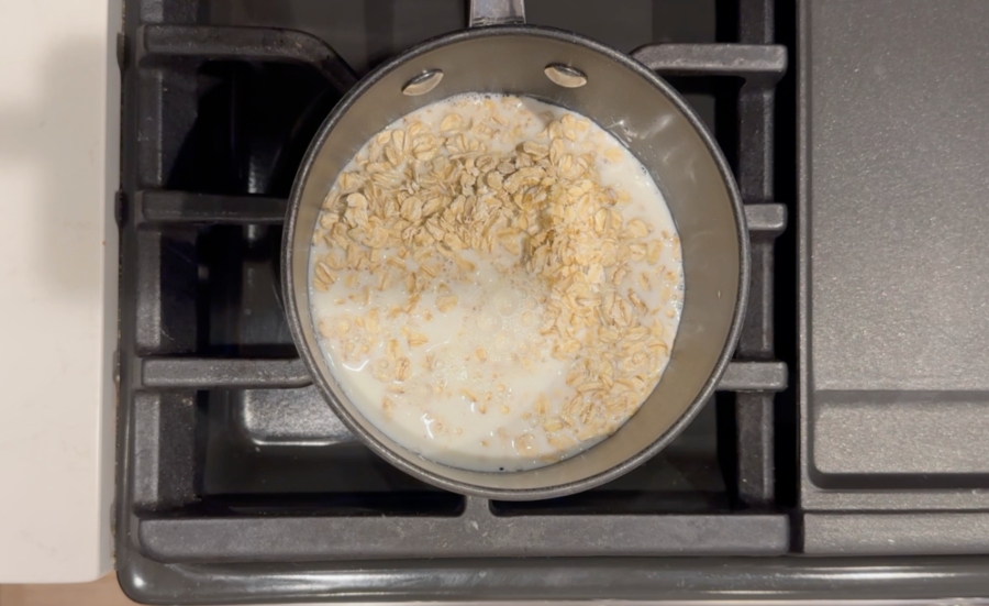 rolled oats, milk, and water in a pot over heat