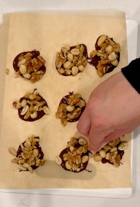 adding nuts to chocolate clusters