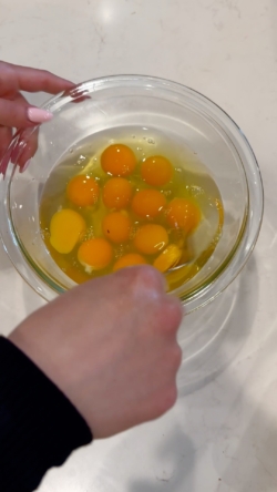 beating 12 eggs in a bowl