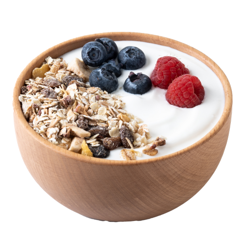 A wooden bowl filled with yogurt, fruit, and nuts. 