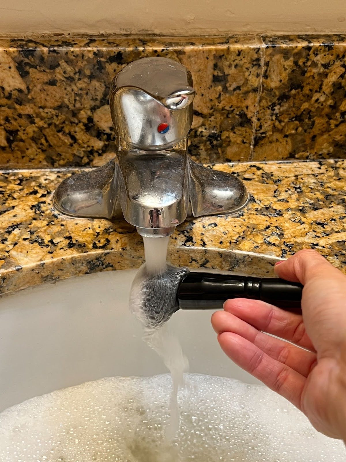 Rinse the makeup brush under running water to clean away soap and makeup, and repeat step 2 until the water runs clear.