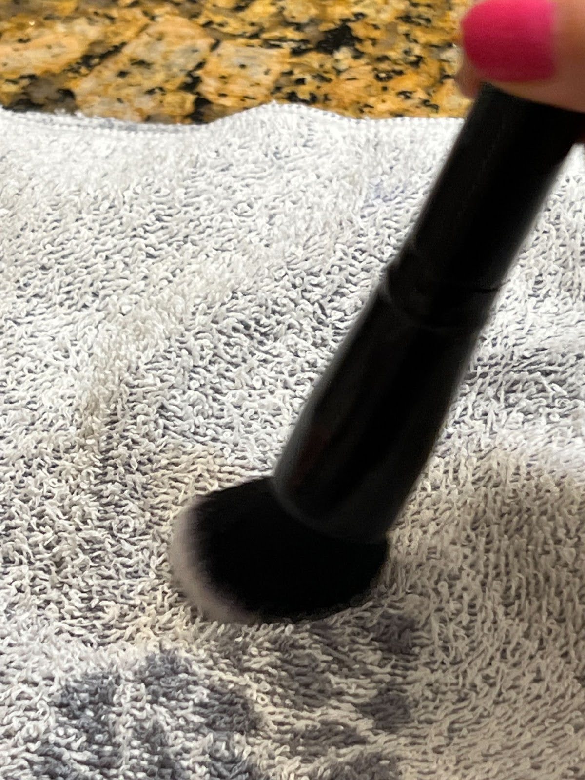 Gently rub the brush bristles on a dry towel (microfiber is best) to get rid of excess water.