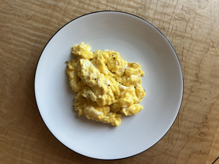 A plate of scrambled eggs. 
