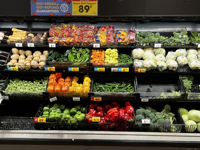 a variety of vegetables on display at the grocery store.