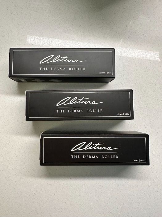 Three black boxes of Alitura Derma Rollers in different needle sizes, including 0.25mm, 0.5mm, and 1.0mm.