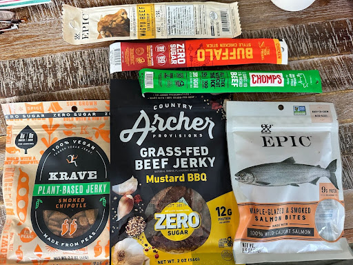 A collection of different varieties of jerky. in packages of varying sizes. 