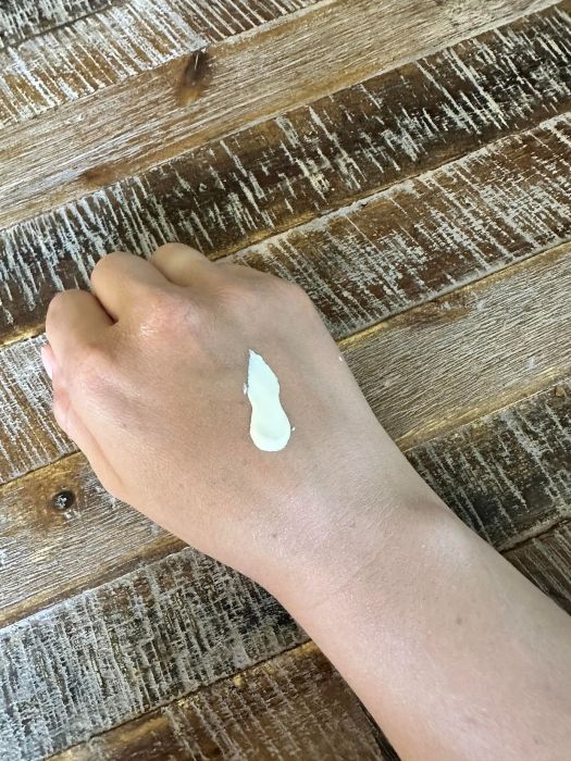 Image of  Earth Mama Baby Mineral Sunscreen Lotion applied to hand that has not been rubbed in.