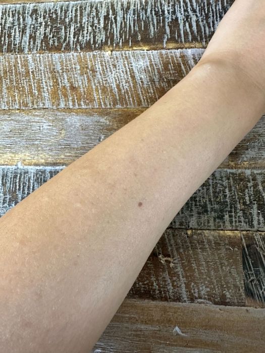 Image of Attitude Sunly Mineral Sunscreen Stick after it has been rubbed into arm skin. 