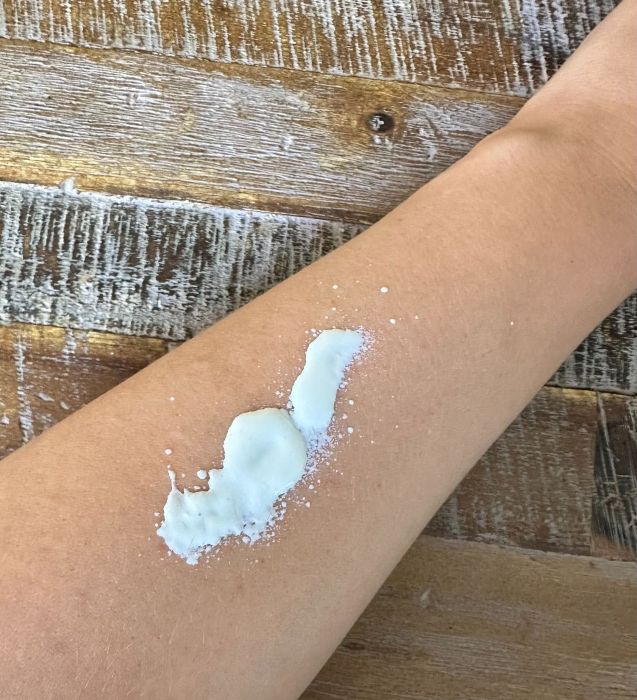 Image of Oars and Alps 100% Mineral Sunscreen Spray on an arm before being spread.